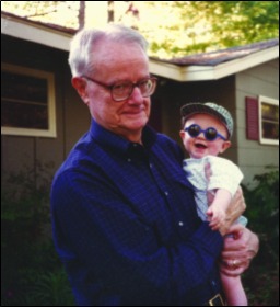 LOUIS LYELL AS A BRAND-NEW GRANDFATHER, WITH SIX-MONTH-OLD CRAWFORD LAMPTON IN HIS ARMS